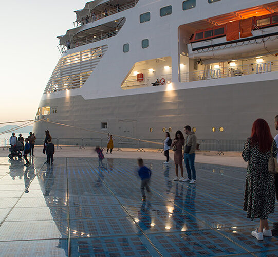 Zadar, Croatia - 30 October 2022: Cruise ship by the touristic attraction Greetings to the sun where families enjoy with their children